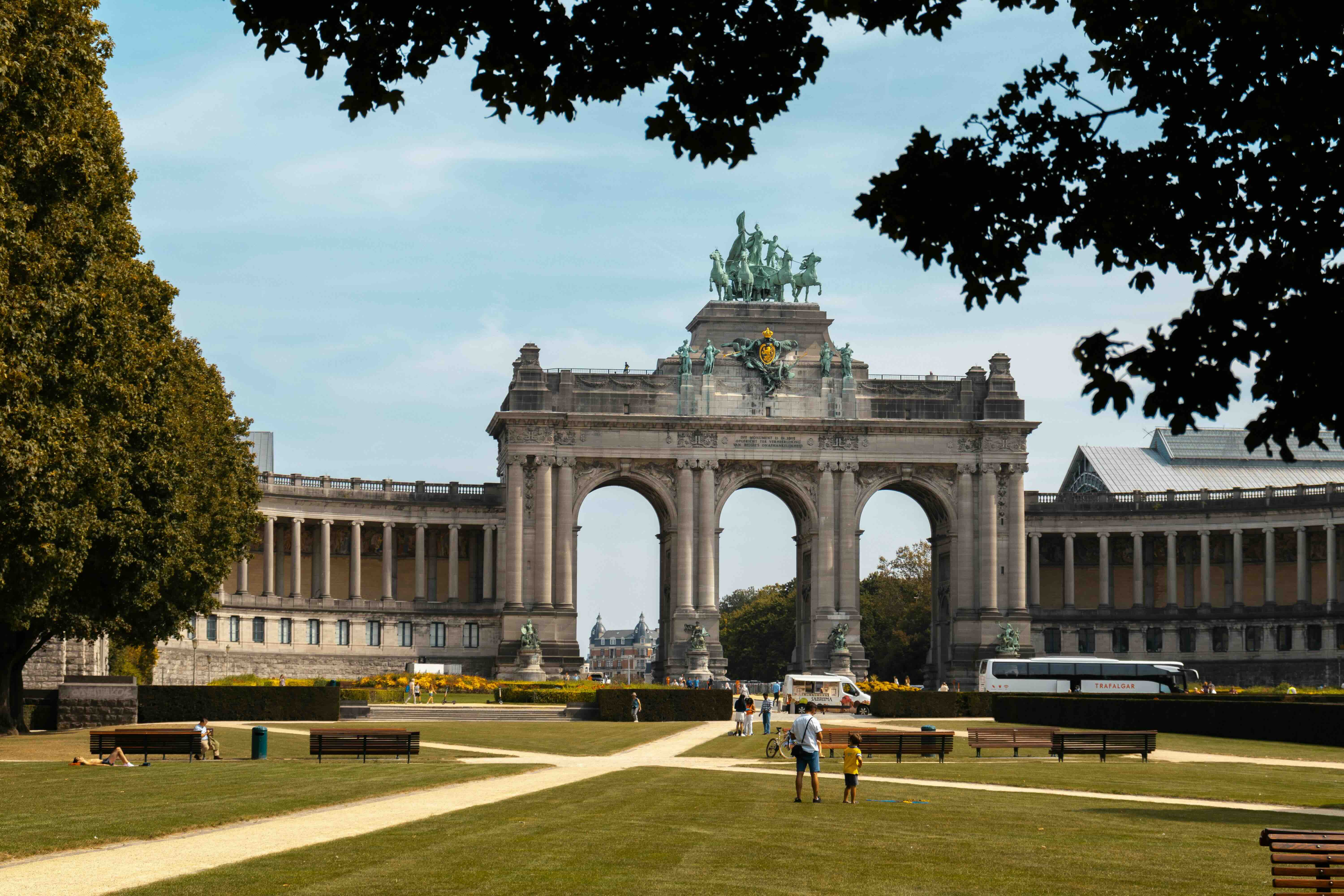 The triumphal arch and bronze quadriga of the Cinquantenaire, framed by trees in the Parc du Cinquantenaire in Brussels