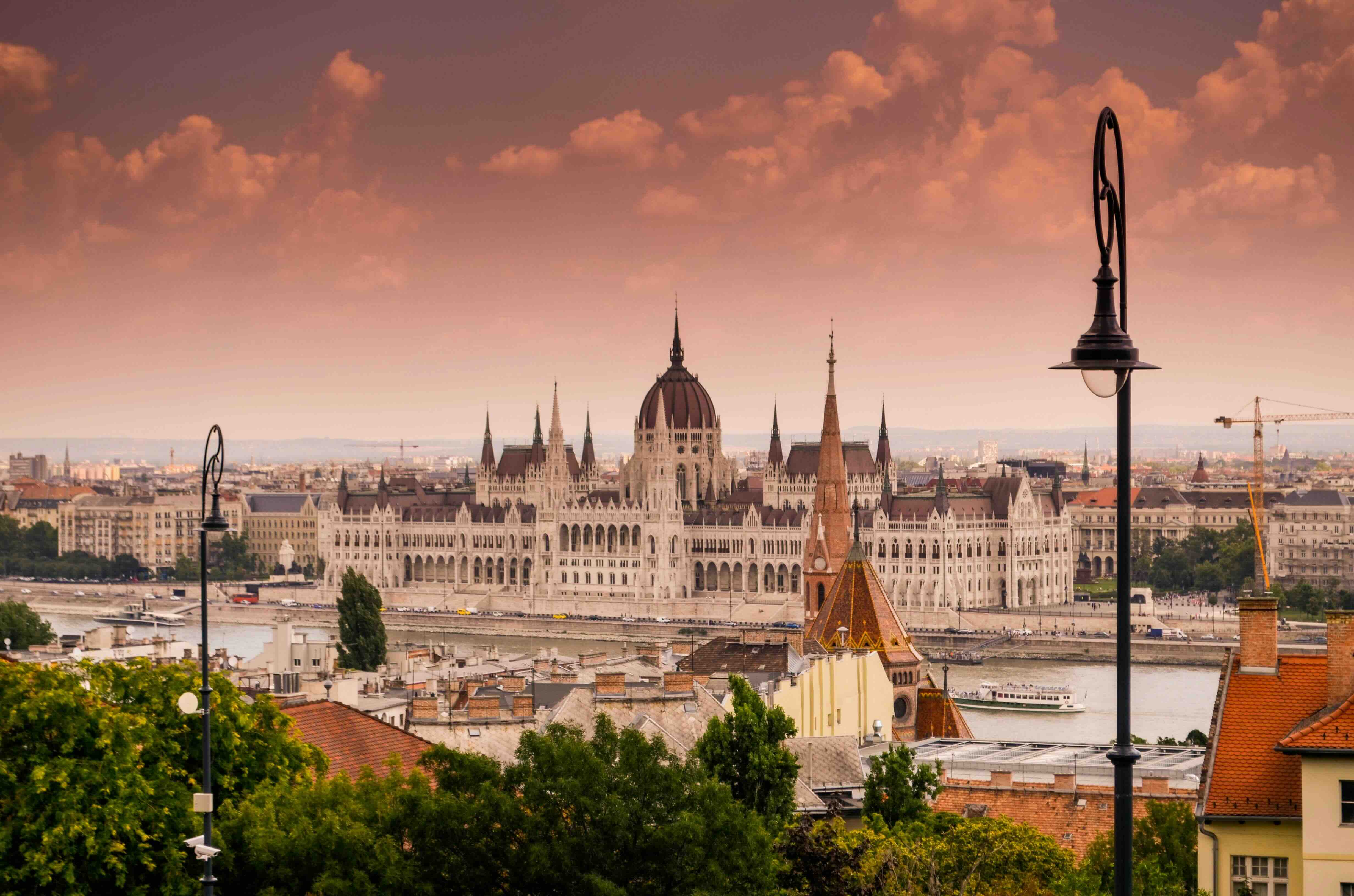 The Hungarian Parliament and its dome on the bank of the Danube in Budapest, seen from the Buda side at dusk