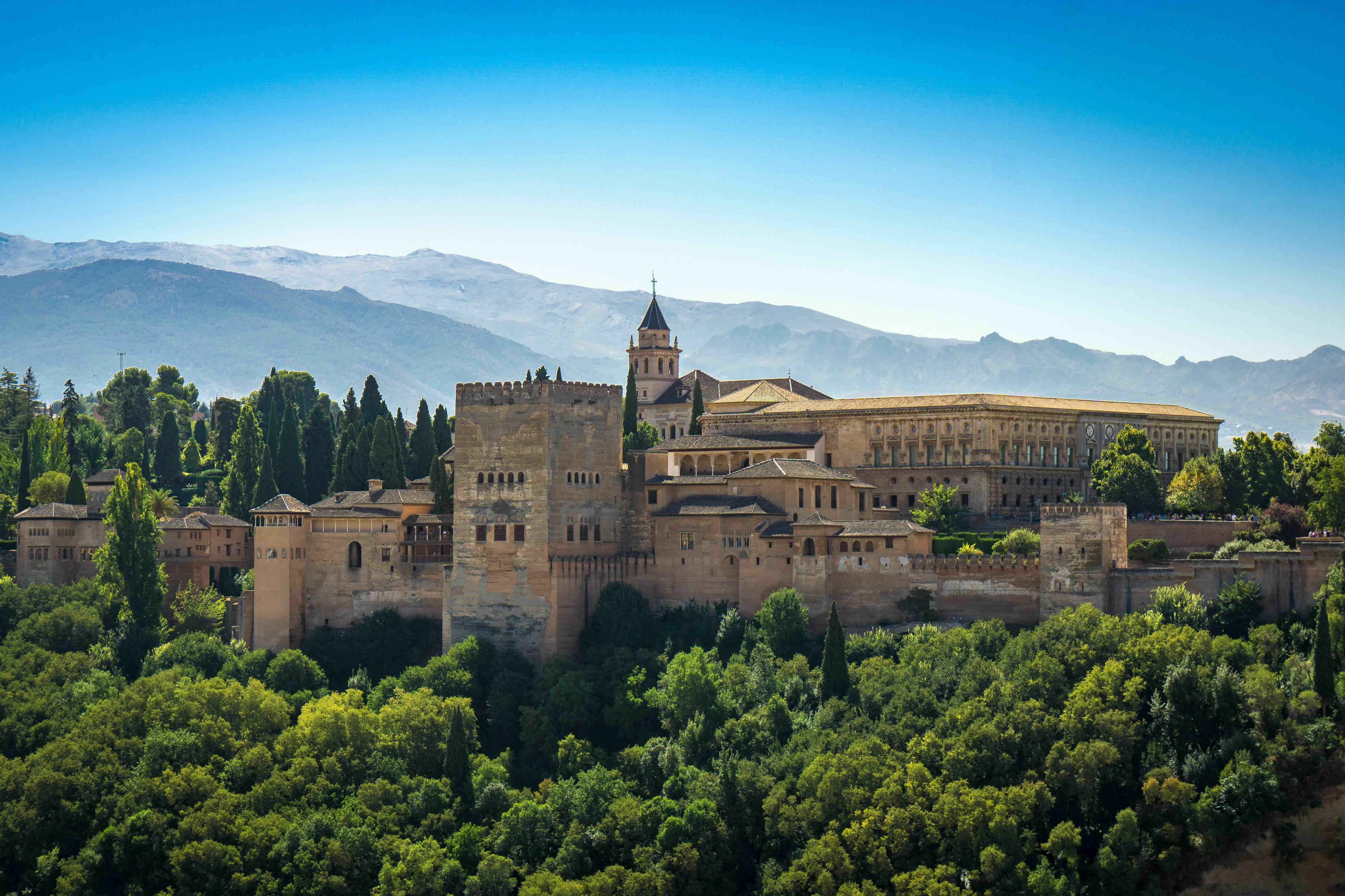 The Alhambra palace complex in Granada with the Sierra Nevada mountains behind