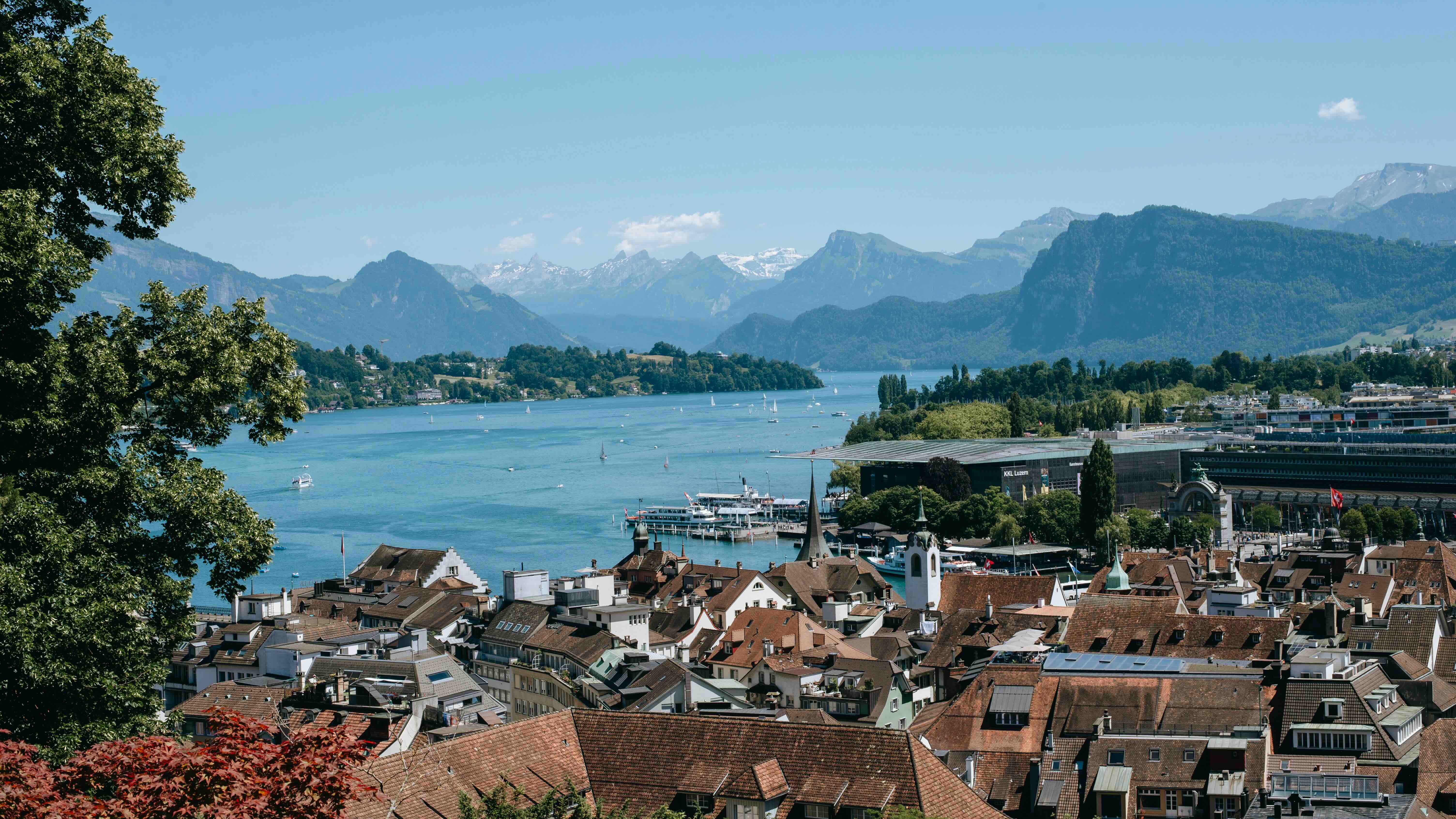 Lucerne's old-town rooftops and Lake Lucerne with paddle steamers and Alpine peaks behind