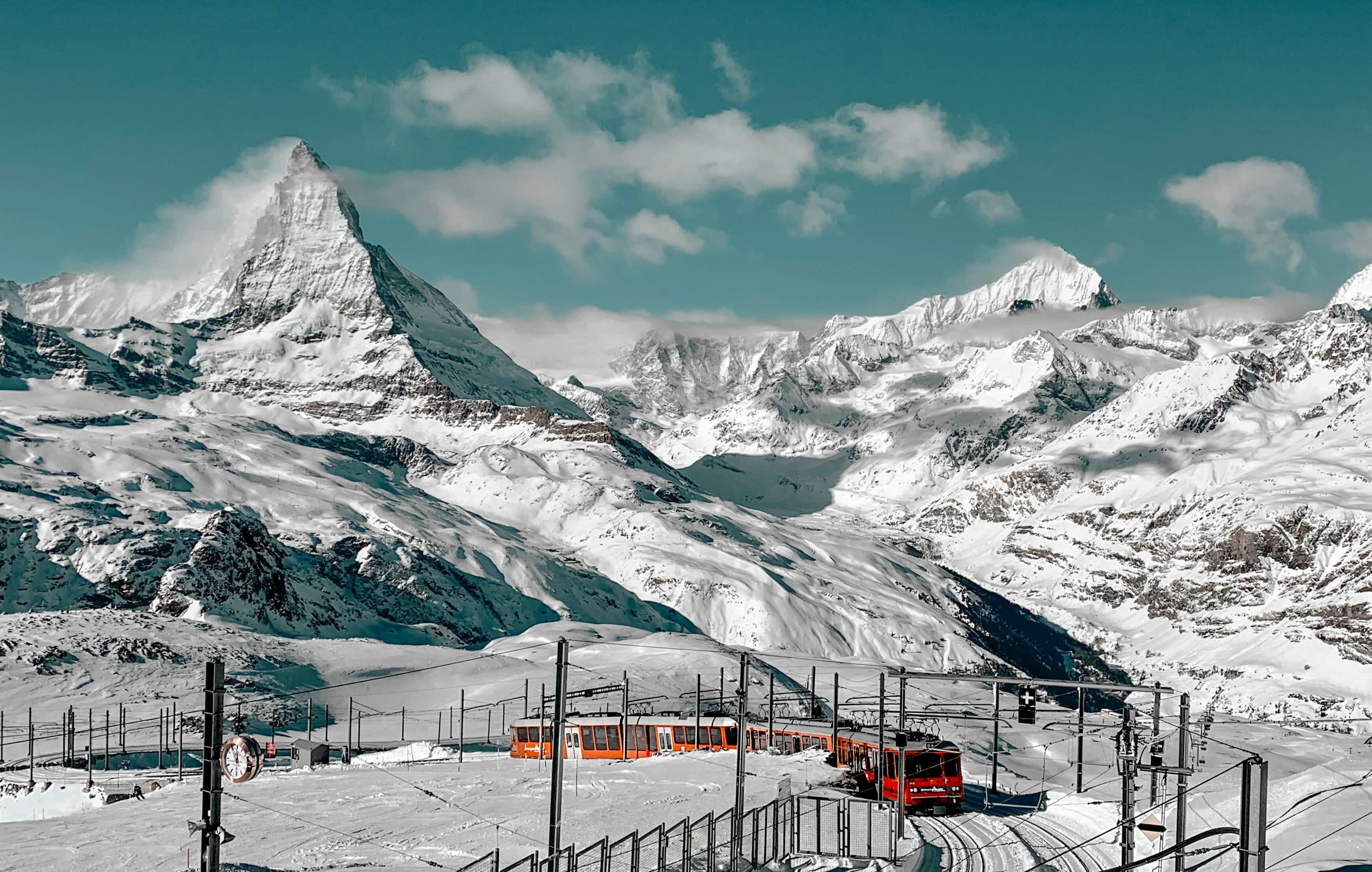 Glacier Express panoramic train crossing a viaduct in the Swiss Alps